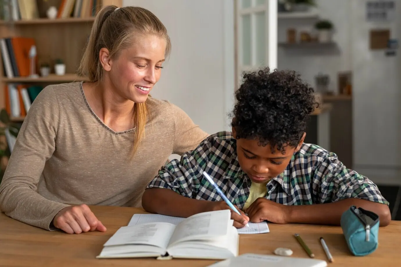 Vorderansicht einer Frau, die einem Kind bei den Hausaufgaben hilft.